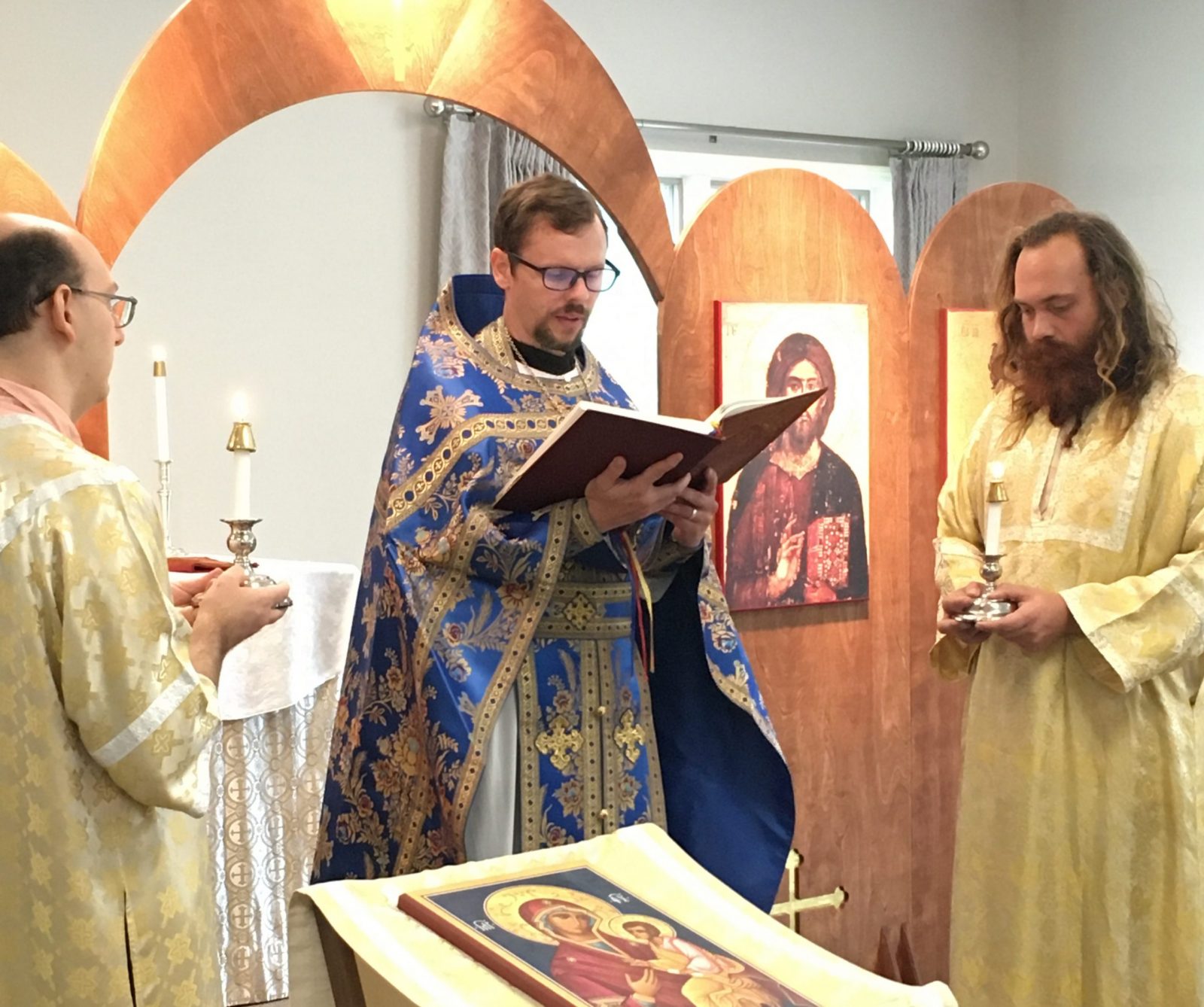 Orthodox priest reading the Gospel during the Divine Liturgy